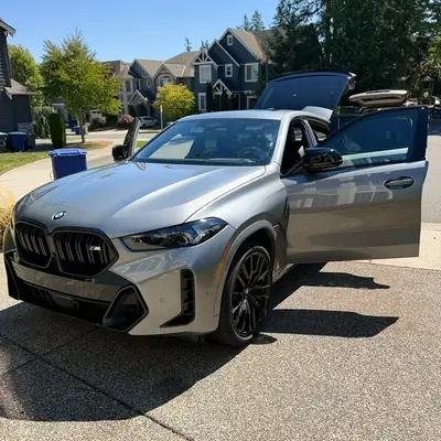 BMW X5 M luxury SUV with pristine ceramic paint finish and open doors